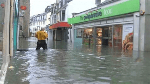 person walking in Looe flood